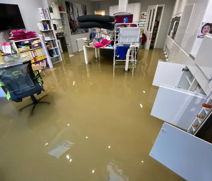 Standing water remains on the floor of a flooded property before Rajvar’s intervention.