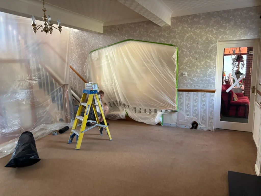 Drying cables and air movers are laid out on a concrete floor during Rajvar’s moisture removal process.